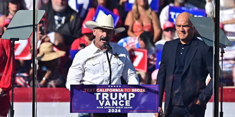 Riverside County Sheriff Chad Bianco addresses supporters of US President and Republican presidential candidate Donald Trump during a rally in Coachella, California on October 12, 2024 / ©AFP