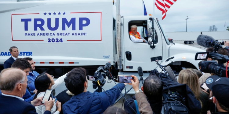 Republican presidential nominee Donald Trump holds a press conference from inside trash hauler at Green Bay Austin Straubel International Airport on October 30, 2024 in Green Bay, Wisconsin. ©AFP