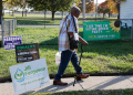 Chester Todd walks past campaign signs outside his home in Racine, Wisconsin, where he's running for the House of Representatives in the state's first district / ©AFP