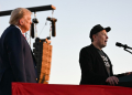 Elon Musk speaks on stage as he joins Donald Trump during a campaign rally / ©AFP