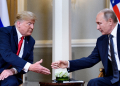 Then US president Donald Trump and Russian President Vladimir Putin reach to shake hands before a meeting in Helsinki on July 16, 2018 / ©AFP