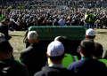 People pray over the casket of Turkish Muslim cleric Fethullah Gulen during a service at Skylands Stadium in Augusta, New Jersey. ©AFP