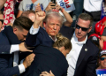 Republican presidential candidate Donald Trump ducked down as Secret Service agents flooded the stage during an assassination attempt in July. ©AFP