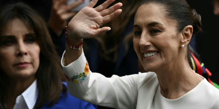 Claudia Sheinbaum waves as she arrives at Congress for her inauguration as the first woman president in Mexican history. ©AFP