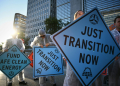 Activists protest against investment in fossil fuels outside of the World Bank headquarters in Washington, DC. ©AFP