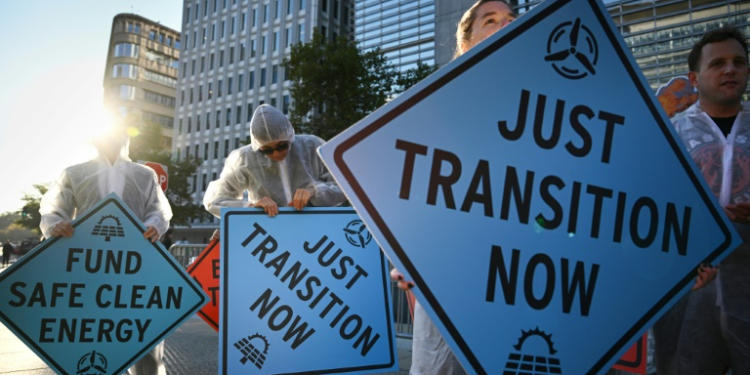 Activists protest against investment in fossil fuels outside of the World Bank headquarters in Washington, DC. ©AFP