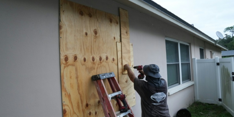 A resident boards up his windows in Palm Harbor, Florida, ahead of Hurricane Milton's expected mid-week landfall . ©AFP