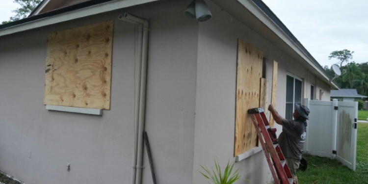 A resident boards up his windows in Palm Harbor, Florida, ahead of Hurricane Milton's expected mid-week landfall. ©AFP