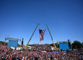 Former president Donald Trump's plane, known as Trump Force One, flies over the crowd ahead of his campaign rally in Butler, Pennsylvania / ©AFP