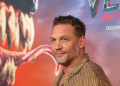 Tom Hardy, star of 'Venom: The Last Dance,' is seen before a poster of the film at its New York premiere on October 21, 2024 . ©AFP