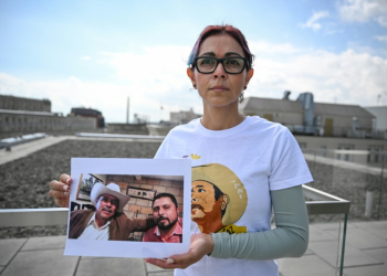 Brenda Diaz Valencia is seen in Washington holding a photo of her father, Antonio Diaz Valencia, and his colleague Ricardo Lagunes, both of whom disappeared after criticizing mining practices in Mexico. ©AFP