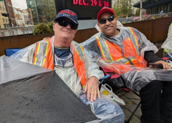 Jeff Dickerson (L) and Nigel Mahabir (R) wait in line to enter a campaign rally for Republican presidential candidate Donald Trump in Grand Rapids, Michigan. ©AFP