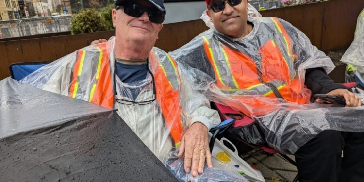 Jeff Dickerson (L) and Nigel Mahabir (R) wait in line to enter a campaign rally for Republican presidential candidate Donald Trump in Grand Rapids, Michigan. ©AFP