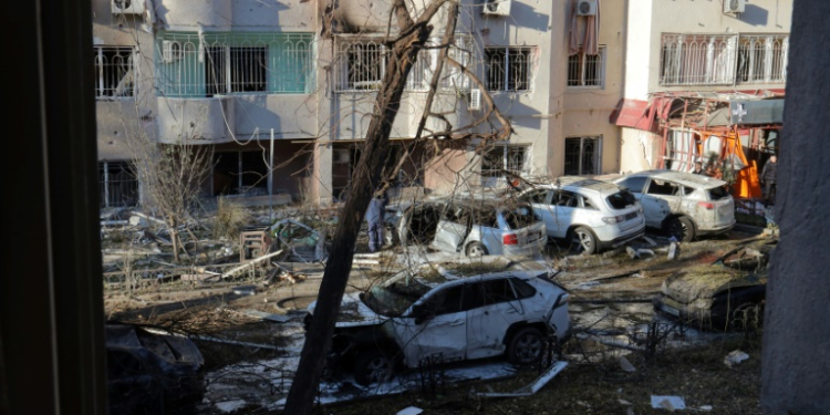 Local residents inspect damage to a residential building and cars following a missile attack in Odesa. ©AFP