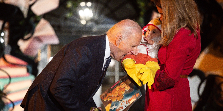 Joe Biden jokingly bit a baby dressed as a chicken as he hosted a Halloween trick-or-treat event at the White House / ©AFP