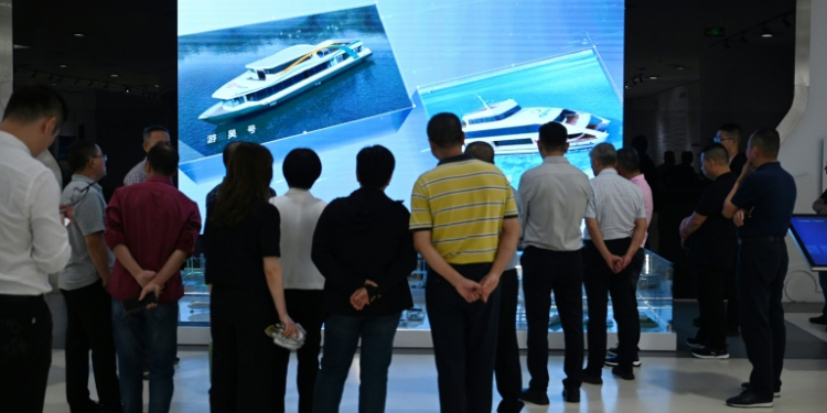 Visitors look at a video about battery-powered ships in the showroom at the headquarters of Chinese EV battery maker CATL in Ningde, Fujian province on November 15, 2024. ©AFP