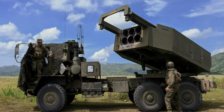 US Marine officers stand next to a HIMARS during live fire exercises with the Philippine Marine Corps in October 2022. ©AFP