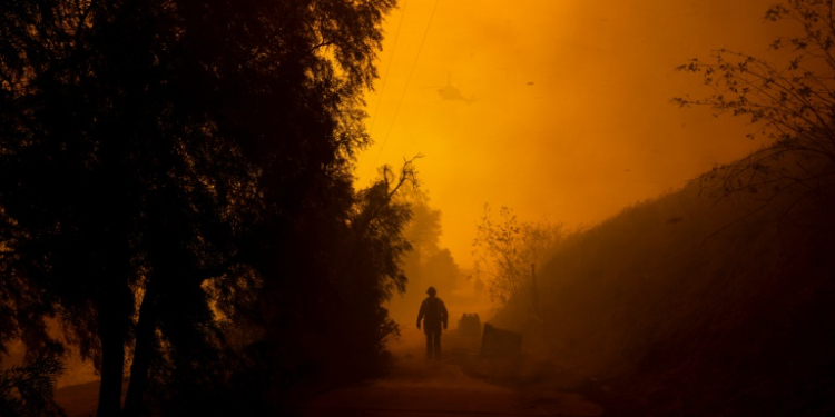 Fierce gusts up to 80 miles (130 kilometers) an hour were pushing smoke sideways and fueling flames that were scorching through California farmland. ©AFP