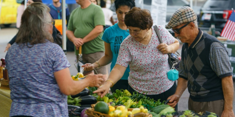 People shop for fresh produce and food at a farmer's market on June 29, 2021, in Homewood, Alabama. ©AFP