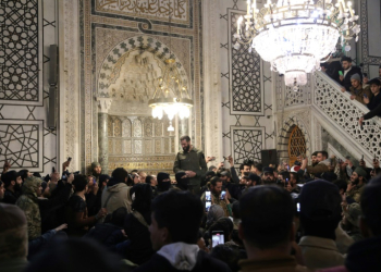 The leader of Syria's Islamist Hayat Tahrir al-Sham group that seized Damascus, Abu Mohammed al-Jolani, addresses a crowd at the capital's landmark Umayyad Mosque on December 8, 2024. ©AFP