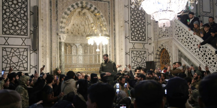 The leader of Syria's Islamist Hayat Tahrir al-Sham group that seized Damascus, Abu Mohammed al-Jolani, addresses a crowd at the capital's landmark Umayyad Mosque on December 8, 2024. ©AFP