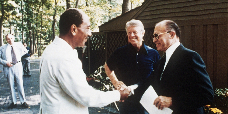 Then US president Jimmy Carter looks on  in September 1978 as Egyptian president Anwar al-Sadat (left) shakes hands with Israeli premier Menachem Begin during negotiations at the Camp David retreat on a historic peace deal / ©AFP