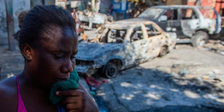 A woman cries after armed gangs shot her husband dead in Port-au-Prince, Haiti . ©AFP