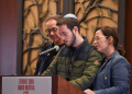 At a Jewish community center in Syosset, New York, Daniel Neutra, with his parents Ronen and Orna, speaks at a memorial ceremony for his brother Omer, who died in the October 7 Hamas attack on Israel . ©AFP