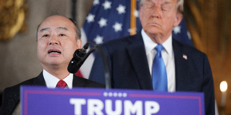 SoftBank CEO Masayoshi Son delivers remarks while US President-elect Donald Trump looks on at Mar-a-Lago in Florida on December 16, 2024 / ©AFP