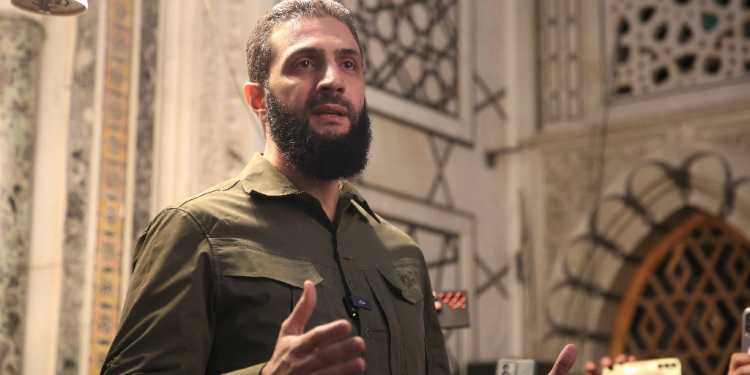 The leader of Syria's Islamist Hayat Tahrir al-Sham group that headed a lightning rebel offensive snatching Damascus from government control, Abu Mohammed al-Jolani, address a crowd at the capital's landmark Umayyad Mosque on December 8, 2024 / ©AFP