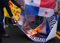 Demonstrators burn Donald Trump's image following his threat to demand control of the Panama Canal be returned to Washington, on December 24, 2024, in Panama City, Panama / ©AFP