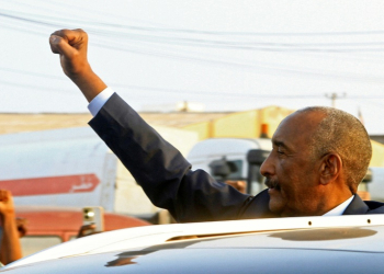 Sudan's army chief Abdel Fattah al-Burhan gestures to people waiting to greet him along a street in Port Sudan on January 14, 2025. ©AFP