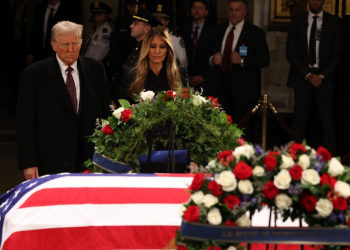 US President-elect Donald Trump and former US First Lady Melania Trump pay their respects in front of the flag-draped casket of former president Jimmy Carter at the US Capitol Rotunda in Washington, DC, on January 8, 2025 / ©AFP