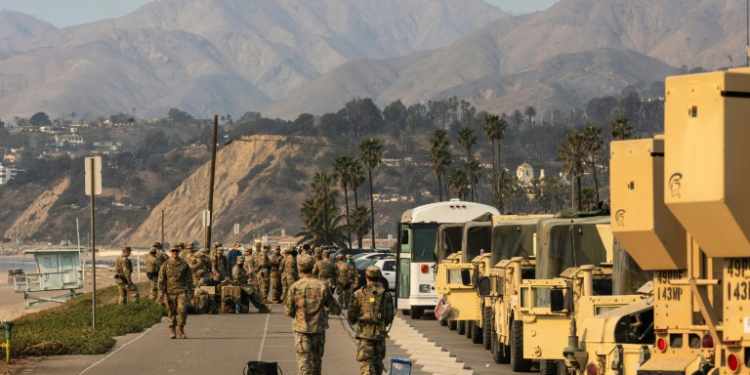 Members of the National Guard take a break along California's Pacific Coast Highway while assisting with various fires on January 10, 2025. ©AFP