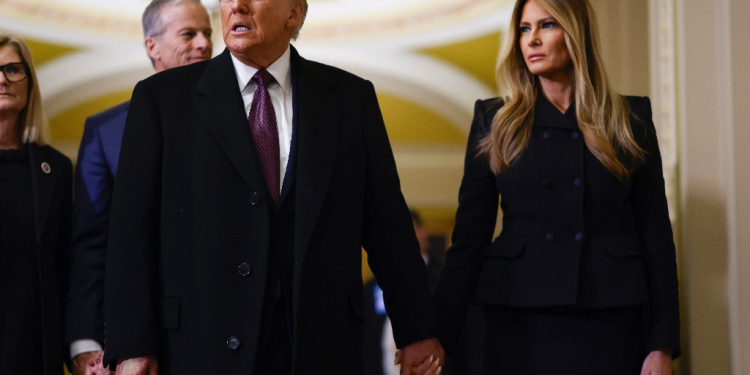 US President-elect Donald Trump and former US First Lady Melania Trump arrive to pay their respects in front of the flag-draped casket of former President Jimmy Carter at the US Capitol Rotunda on January 8, 2025 / ©AFP