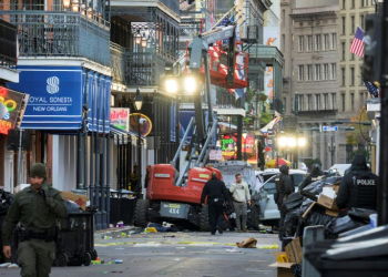 A white Ford F-150 pickup truck crashed into a work lift after allegedly driving into a crowd of New Year's revelers in the French Quarter of New Orleans, Louisiana, on Wednesday. ©AFP