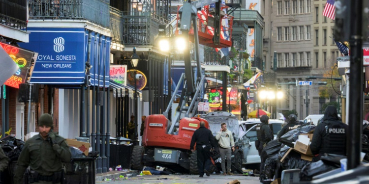 A white Ford F-150 pickup truck crashed into a work lift after allegedly driving into a crowd of New Year's revelers in the French Quarter of New Orleans, Louisiana, on Wednesday. ©AFP