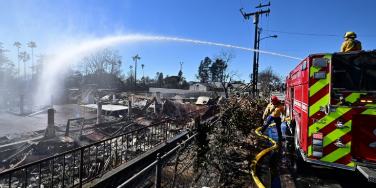 Firefighters water down smoky embers at the fire ravaged Sahag Mesrob Armenian Christian School in Altadena, California. ©AFP