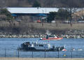 A police boat gathers wreckage along the Potomac River after American Airlines flight 5342 on approach to Reagan National Airport crashed into the river after colliding with a US Army helicopter / ©AFP