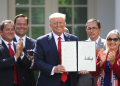 Donald Trump, shown in this July 2020 photo, holds up an executive order he signed during his first term as president  / ©AFP