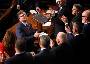 Mike Johnson, seen receiving applause after being re-elected speaker of the US House of Representatives, says he hopes for speedy passage of a massive bill full of Donald Trump's priorities  / ©AFP