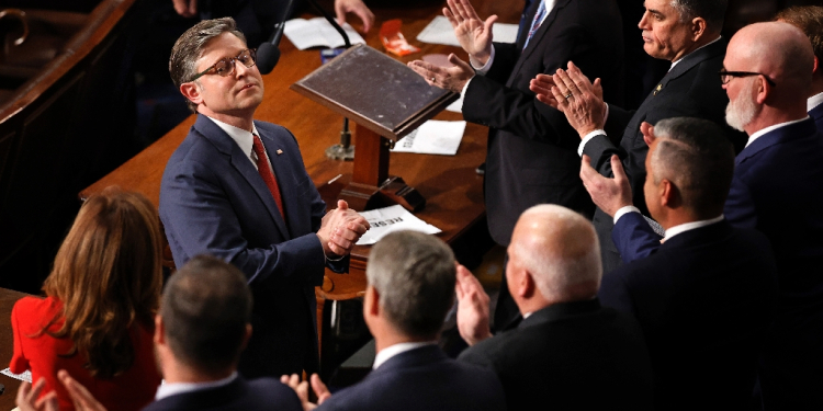 Mike Johnson, seen receiving applause after being re-elected speaker of the US House of Representatives, says he hopes for speedy passage of a massive bill full of Donald Trump's priorities  / ©AFP