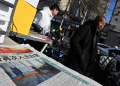 A newspaper featuring an image of Donald Trump arriving at the White House ahead of his inauguration as US President is seen at a news stand in Beijing on January 21 / ©AFP