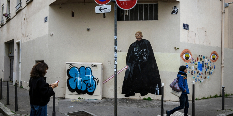 A pedestrian stands next to a graffiti created by French artist Big Ben street Art, depicting US Donald Trump as Darth Vader in Lyon, on November 6, 2024 / ©AFP