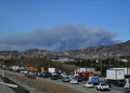 A plume of smoke is seen from the new fire, the Hughes fire, in the Sylmar neighborhood of Los Angeles, California, on January 22, 2025. ©AFP