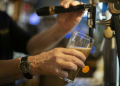 A bartender pours a draft beer in a bar in Brest, western France. ©AFP