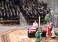 Members of the clergy pray over the casket of former US president Jimmy Carter during his state funeral at Washington National Cathedral, as all five living US presidents look on. ©AFP