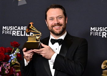 Jason Carter, grandson of former US president Jimmy Carter poses with his grandfather's posthumous Grammy for Best Audiobook, Narration and Storytelling Recording  / ©AFP