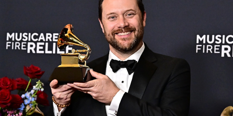 Jason Carter, grandson of former US president Jimmy Carter poses with his grandfather's posthumous Grammy for Best Audiobook, Narration and Storytelling Recording  / ©AFP