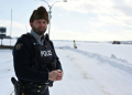 Royal Canadian Mounted Police Corporal Keven Rouleau stands near the Canada-US border, where he says illegal crossings take place in the winter months. ©AFP